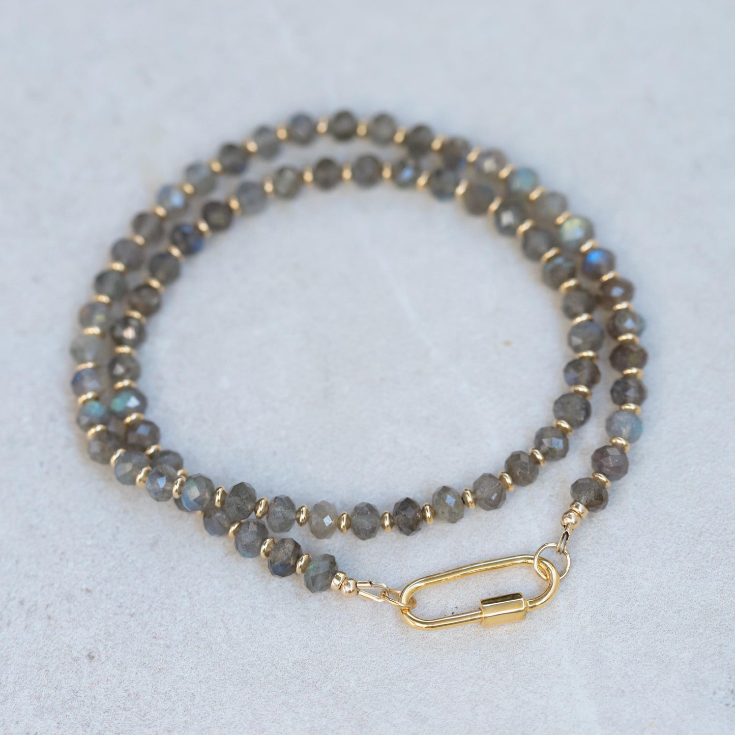 Labradorite carabiner necklace from Earthly Abundance featuring a polished Labradorite stone on a metal chain.