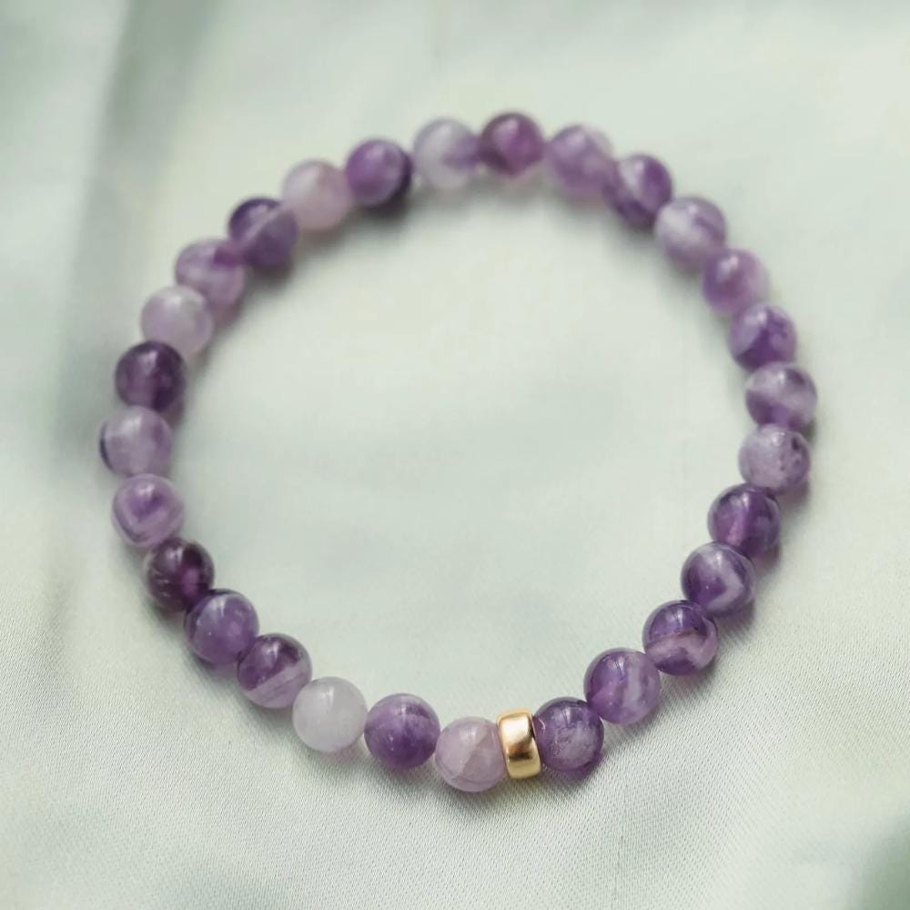 Chevron Amethyst bracelet with polished beads from Earthly Abundance, displayed on a neutral background.
