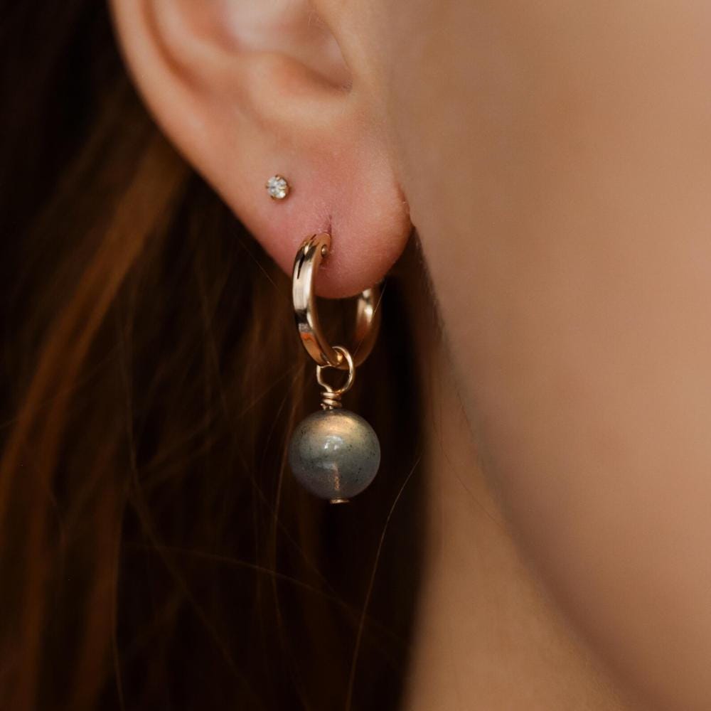 Labradorite ball hoop earrings with 14K gold-filled design, featuring polished labradorite gemstones on gold hoops.