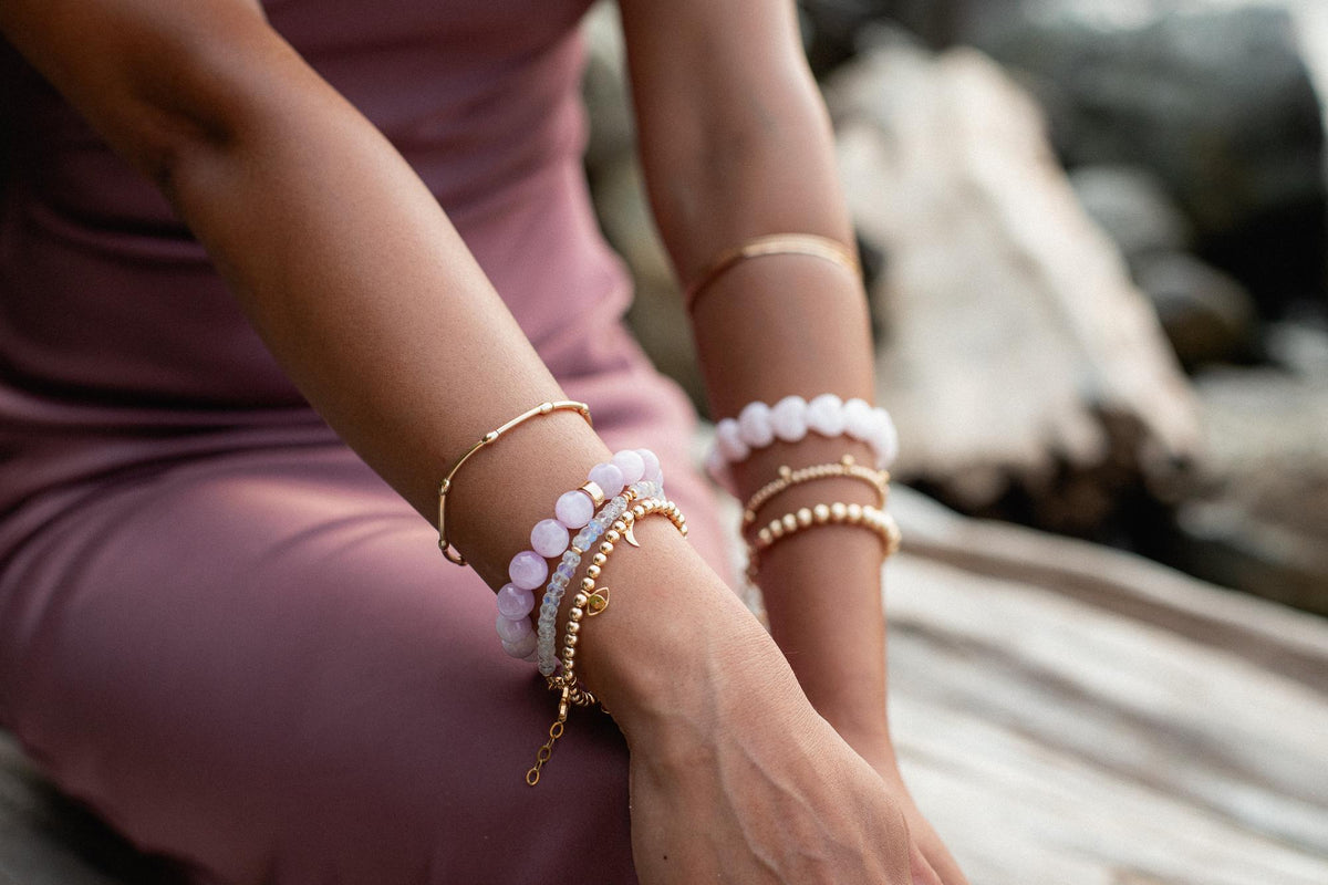 Kunzite bracelet with 10mm pink stones from Earthly Abundance Jewelry, featuring a delicate design on a neutral background.