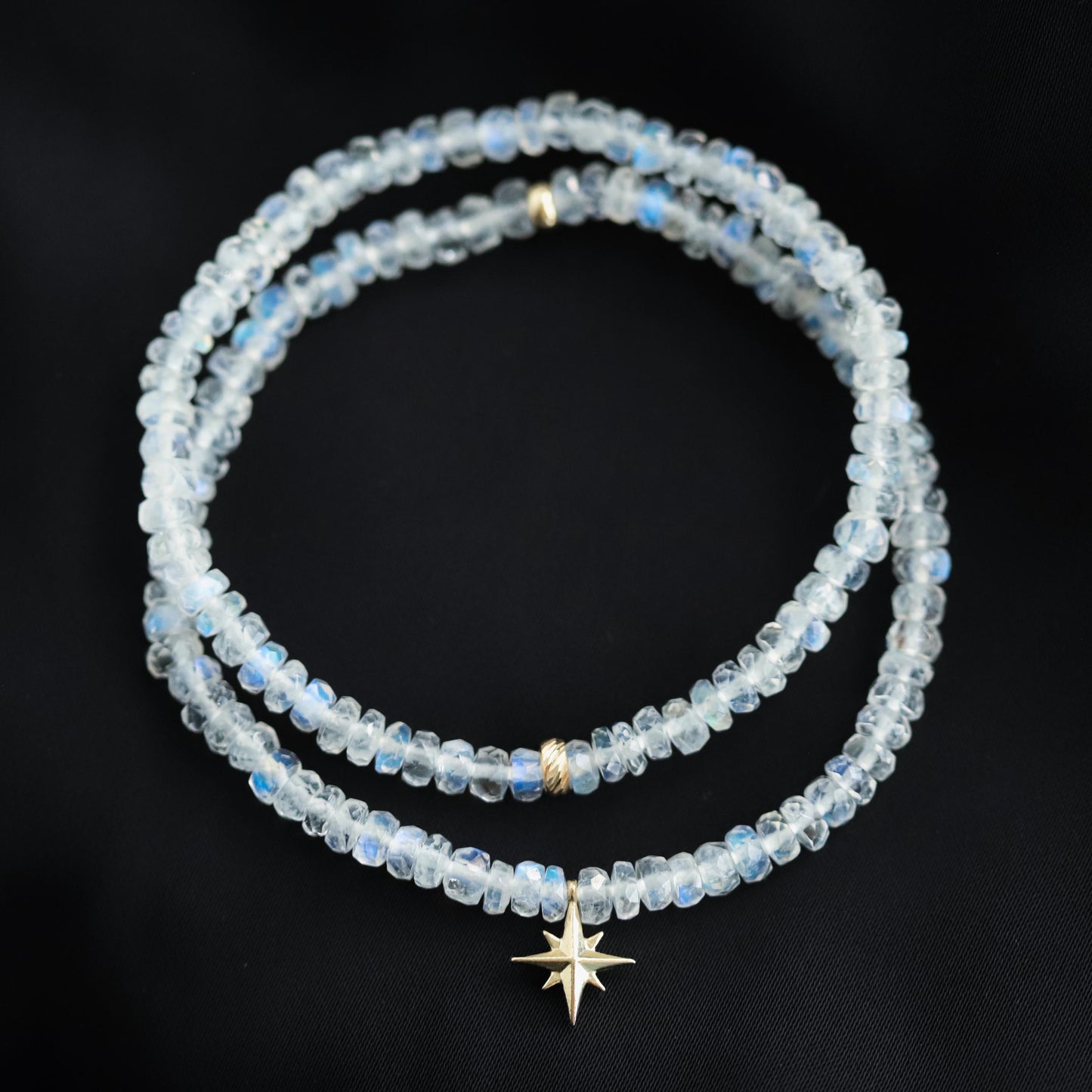 Rainbow moonstone bracelet featuring polished stones set in 14K gold, showcasing iridescent shimmer and elegant jewelry design.