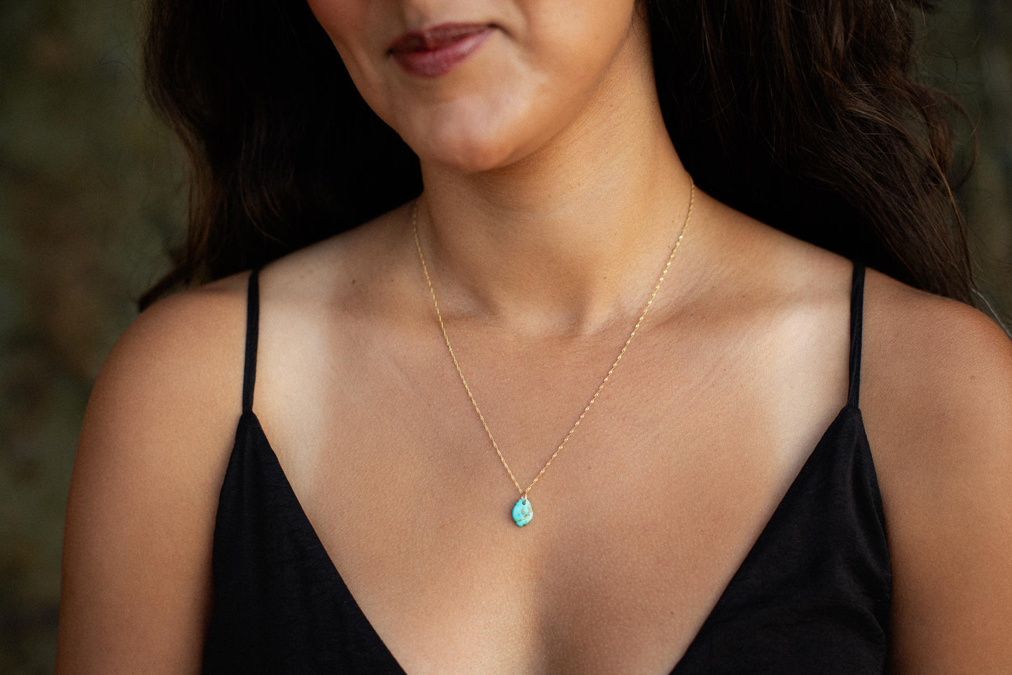Desert Sky Turquoise Necklace by Earthly Abundance featuring a 14K gold chain and vibrant turquoise pendant on a plain background.