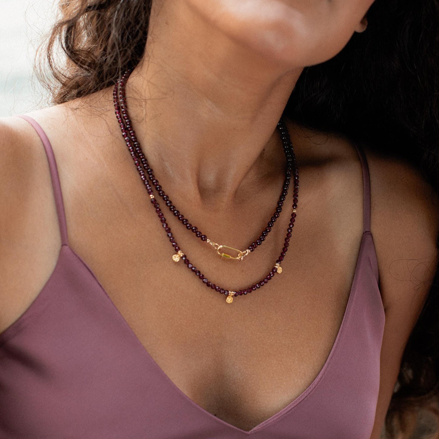 Earthly Abundance Garnet carabiner necklace featuring a vibrant red garnet gemstone on a silver-tone chain.