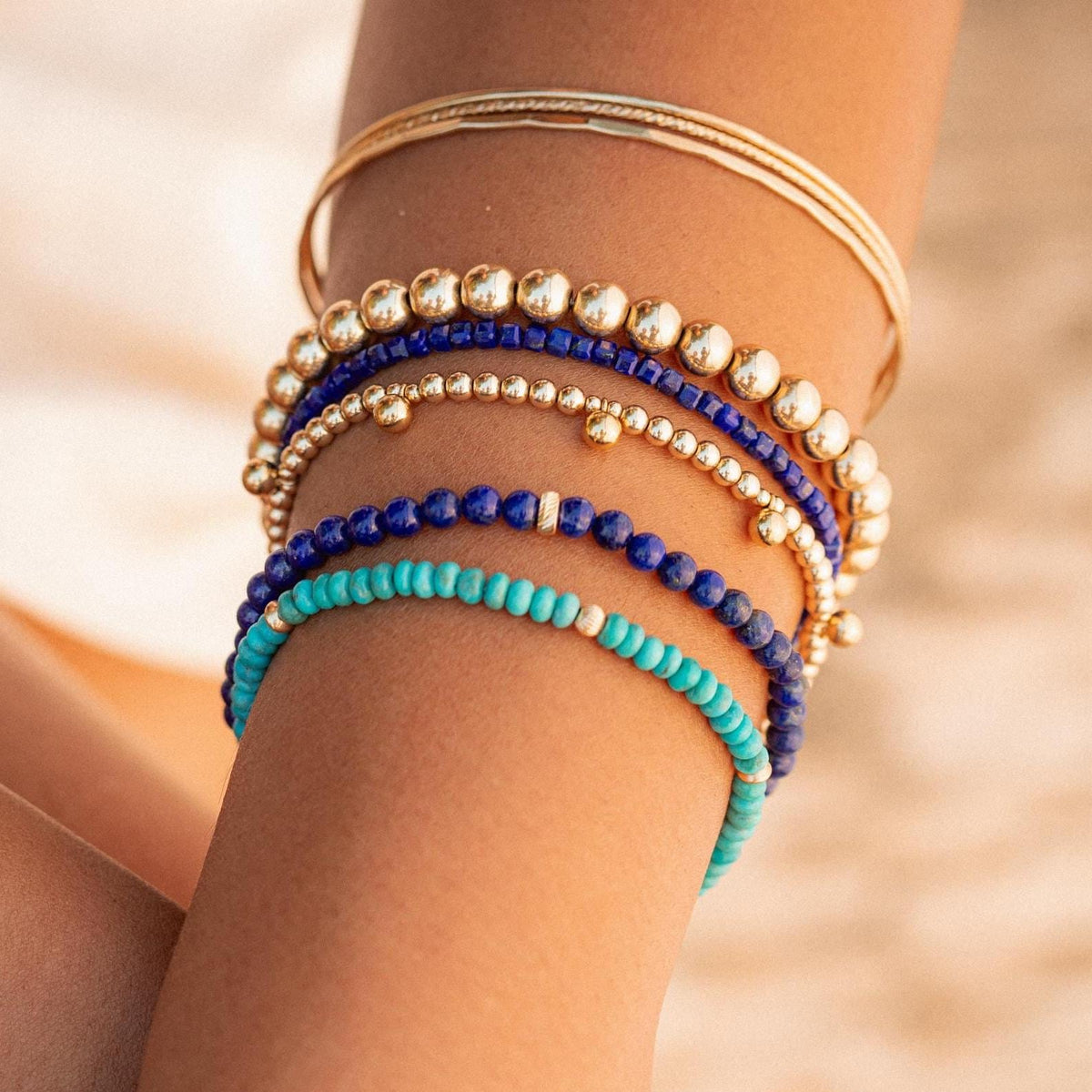 Blue sapphire cube bracelet by Earthly Abundance featuring polished blue sapphire cubes on a delicate chain.