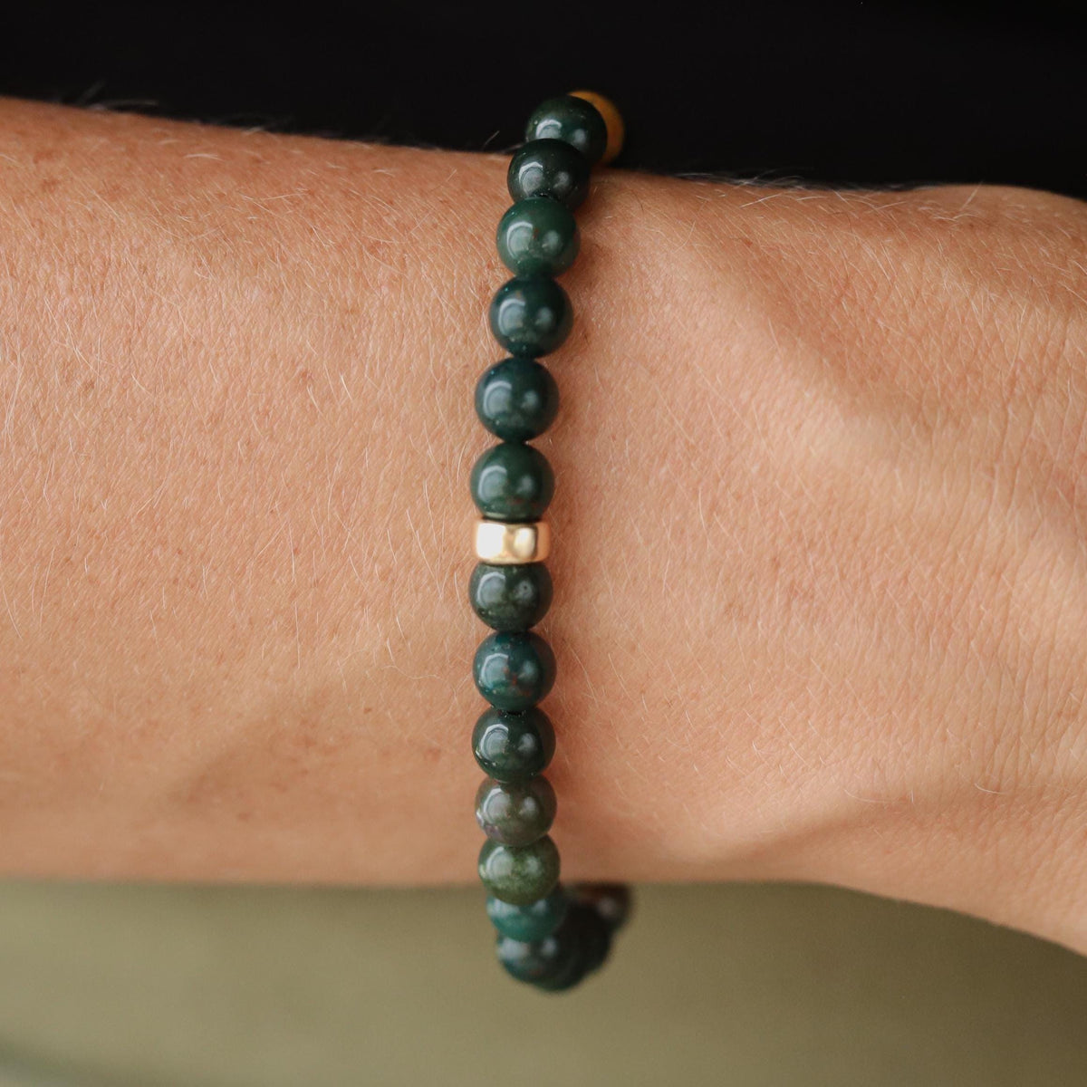 Grounded Strength Bloodstone bracelet from Earthly Abundance featuring polished bloodstone beads on an elastic band.