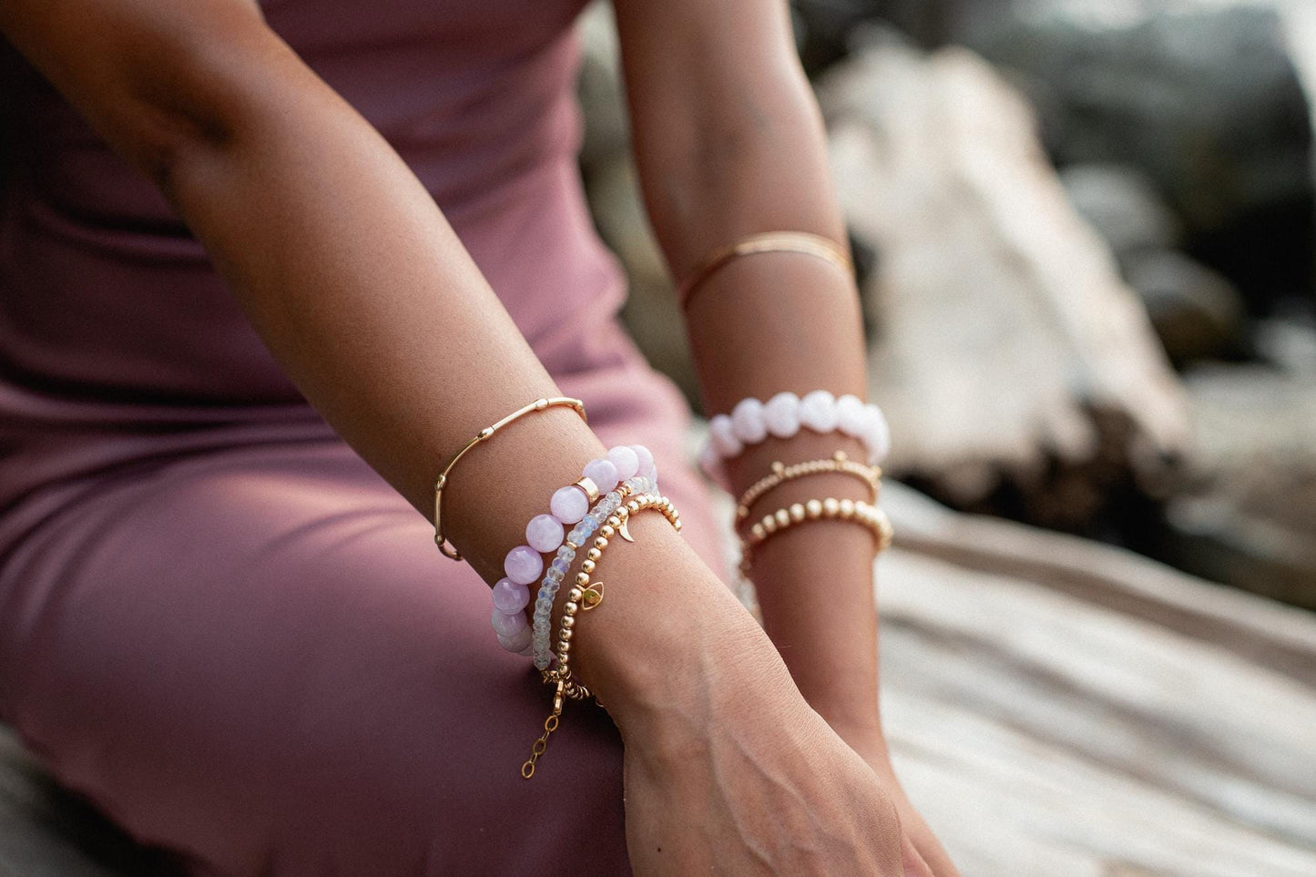 Gold beaded charm bracelet with 4mm beads from Earthly Abundance, featuring small decorative charms on a delicate chain.