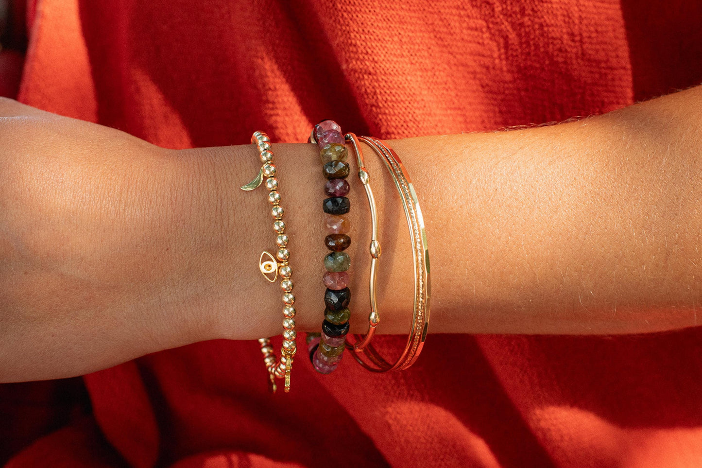 Tourmaline energy bracelet by Earthly Abundance featuring black and pink gemstone beads on an elastic band.