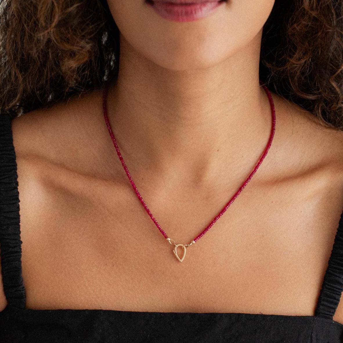 Longido Ruby Carabiner necklace by Earthly Abundance Jewelry featuring a vibrant ruby pendant on a sleek silver chain.