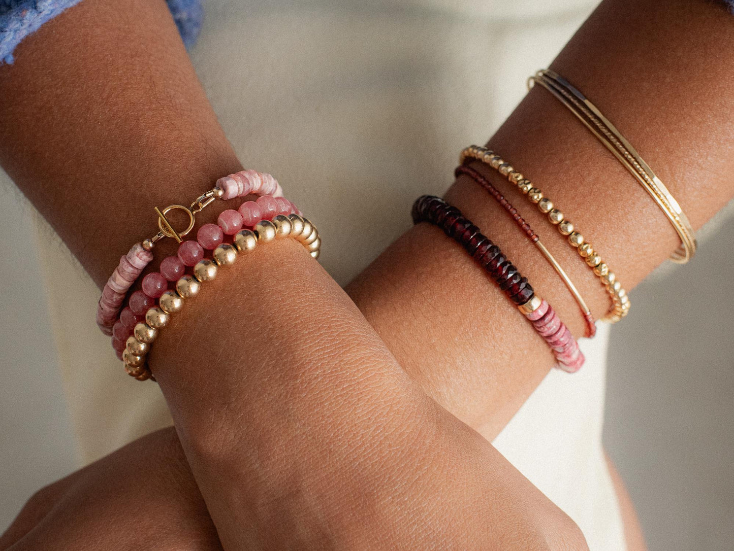 Rhodochrosite gemstone set in 14K gold jewelry, showcasing a polished, deep pink stone with gold accents.