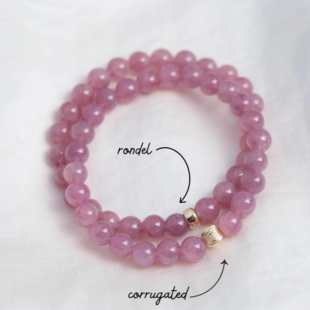 Madagascar Rose Quartz bracelet by Earthly Abundance featuring polished pink quartz beads on an elastic band.