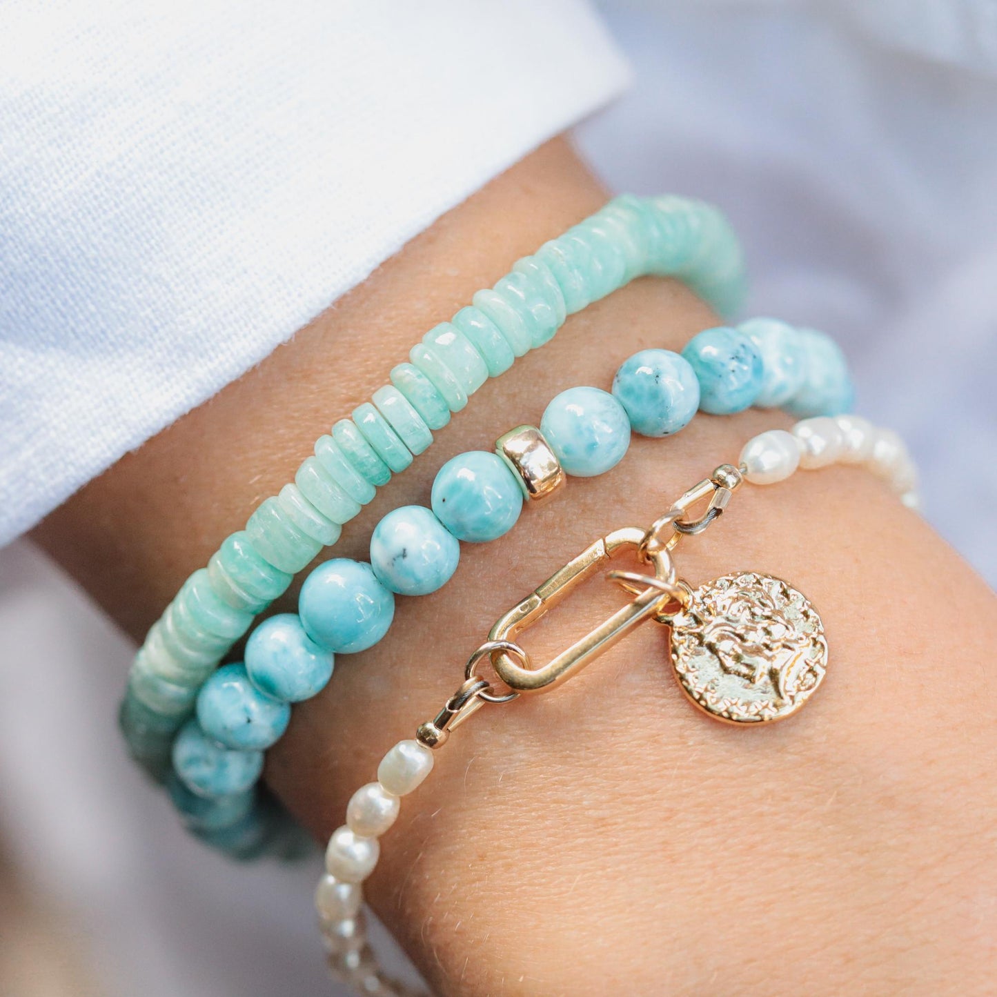Pearl carabiner bracelet by Earthly Abundance featuring white pearls and a metal carabiner clasp on a neutral background.