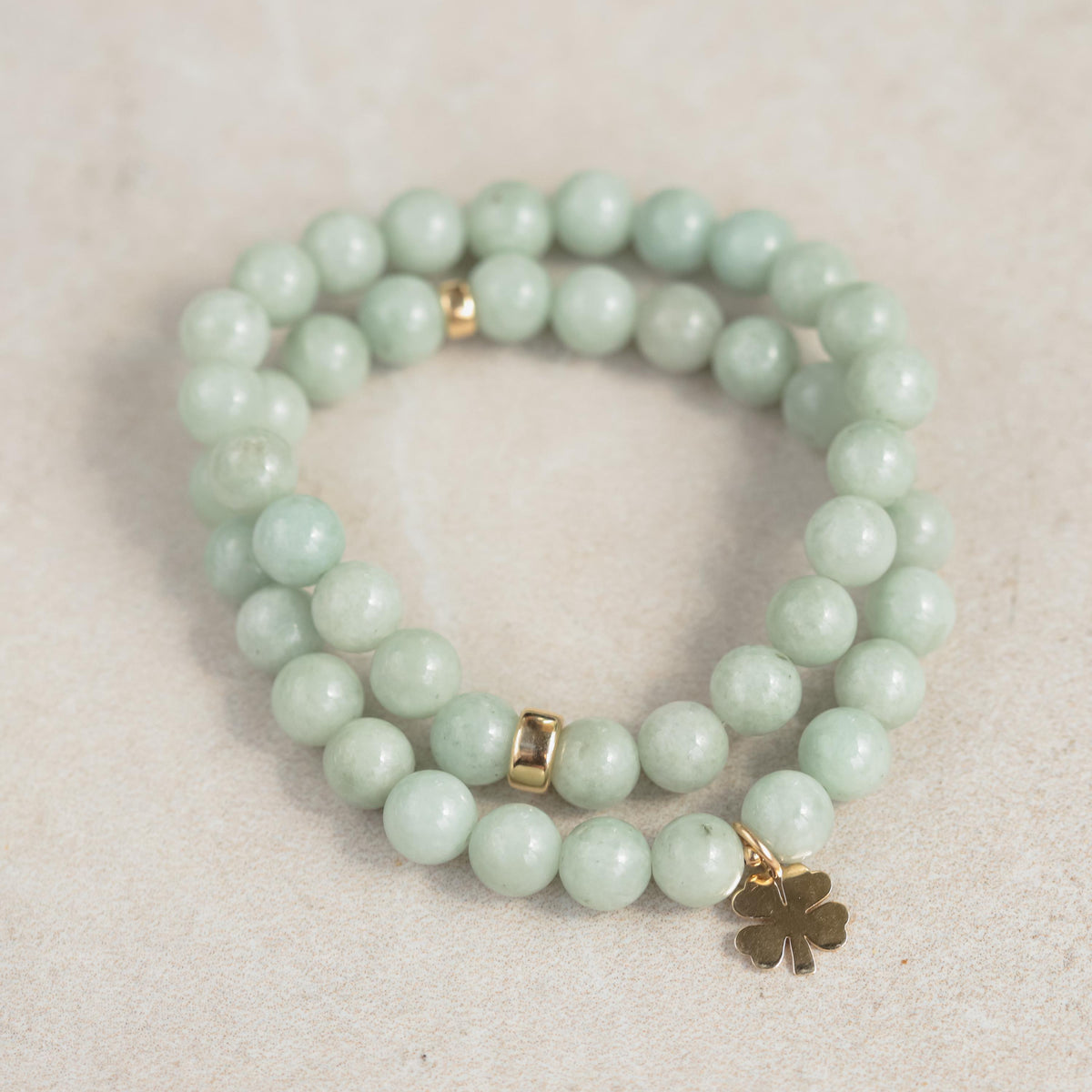 Jadeite Clover Bracelet by Earthly Abundance featuring green jadeite stones with a silver clasp and clover charm design.