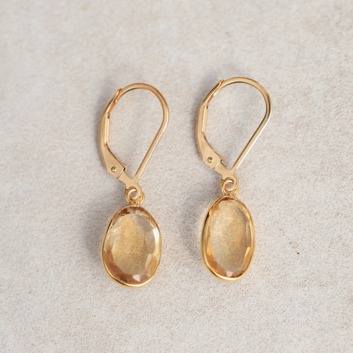 14K Citrine Abundance Earrings by Earthly Abundance featuring sparkling yellow citrine stones and gold hooks.