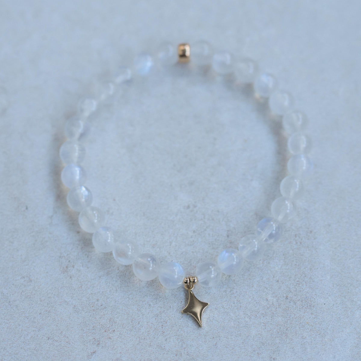 Rainbow moonstone bracelet by Earthly Abundance featuring a 14K gold clasp and colorful, polished moonstone beads.