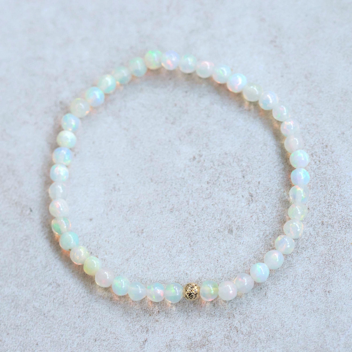 Ethiopian Opal Pyramid Bracelet with 14K gold setting from Earthly Abundance, featuring a pyramid-shaped opal gemstone.
