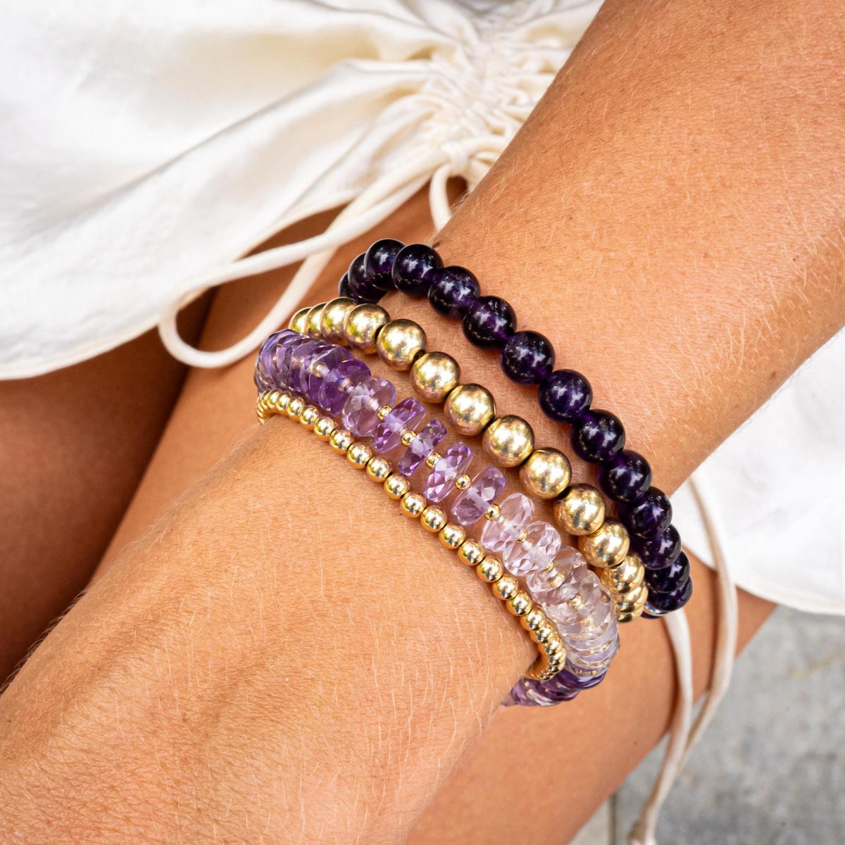 Amethyst Heishi Ombre bracelet by Earthly Abundance featuring graduated purple stone beads on an elastic band.