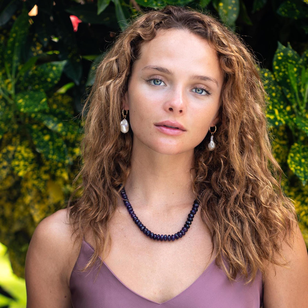 Faceted African amethyst statement necklace featuring large purple gemstones on a silver chain, crafted by Earthly Abundance.