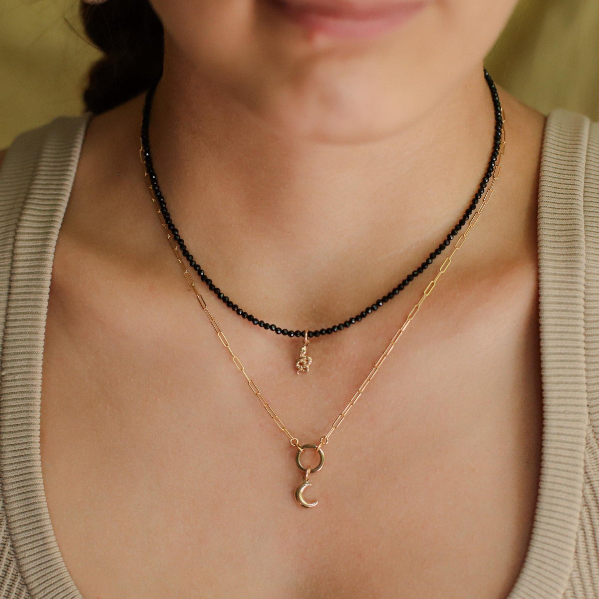 Black tourmaline snake necklace with 14K gold accents, featuring a detailed snake design, from Earthly Abundance.