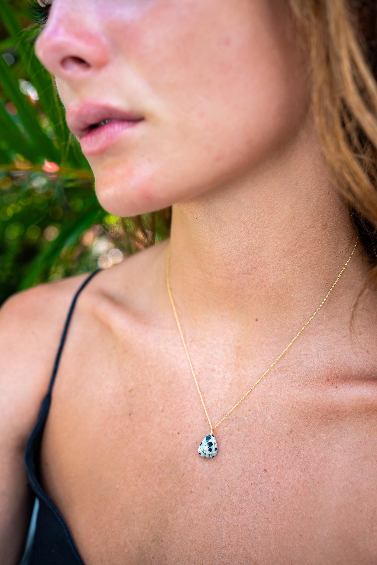 Dalmatian Jasper pendant from Earthly Abundance featuring black and cream spotted stone on a silver chain.