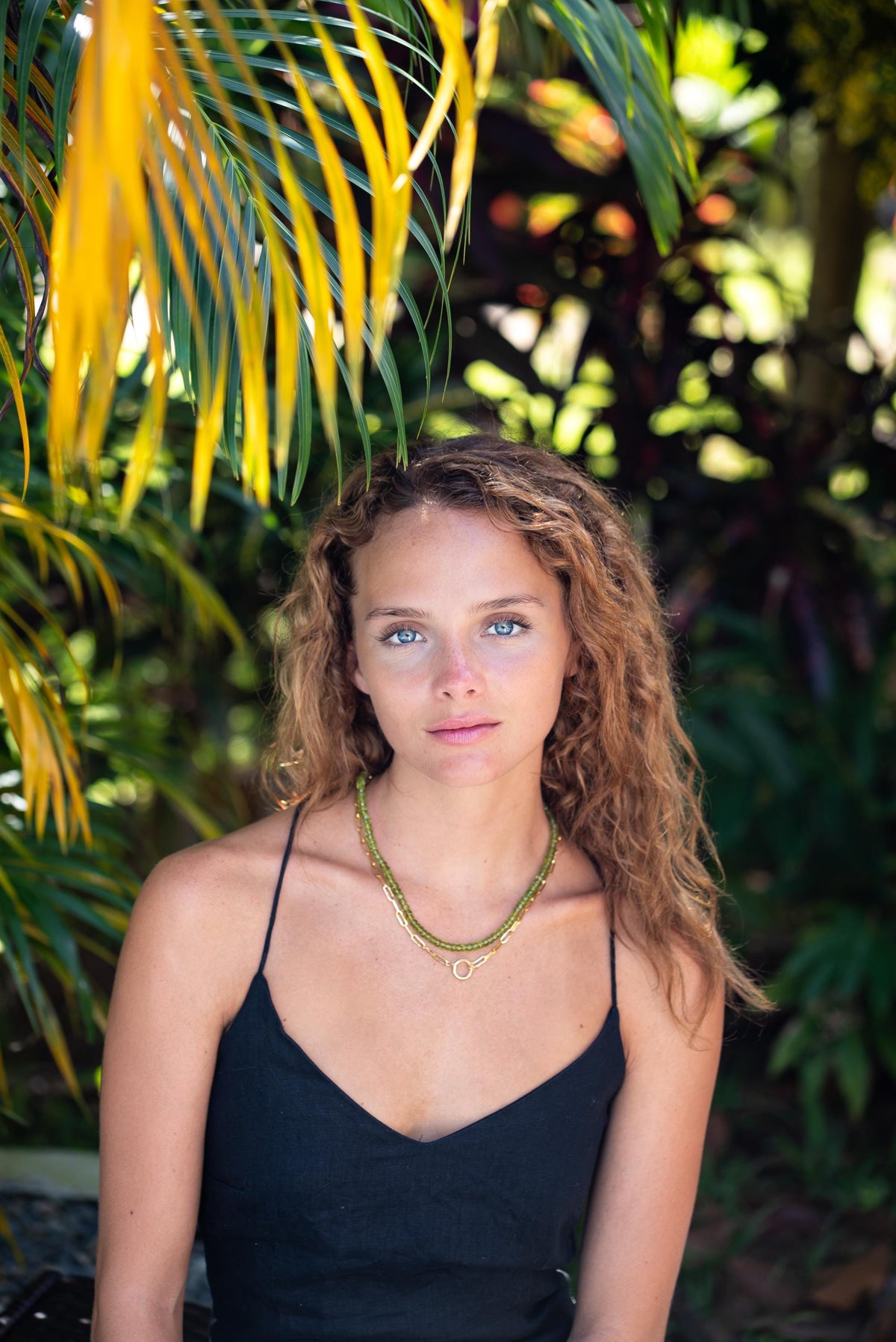 14K Peridot necklace from Earthly Abundance featuring a vibrant green peridot gemstone on a delicate gold chain.
