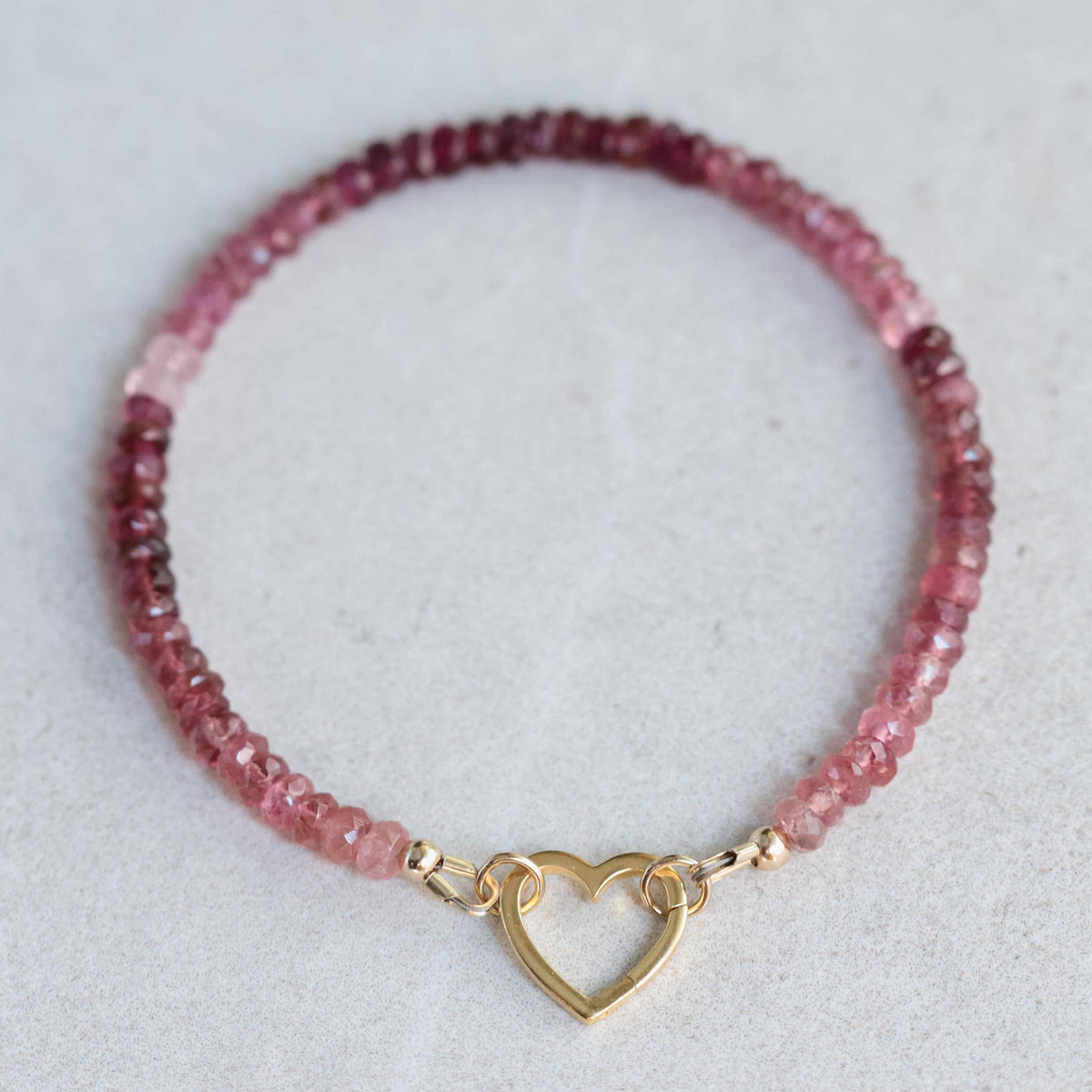 Pink tourmaline carabiner bracelet by Earthly Abundance Jewelry featuring soft radiance pink stones and a sturdy metal clasp.