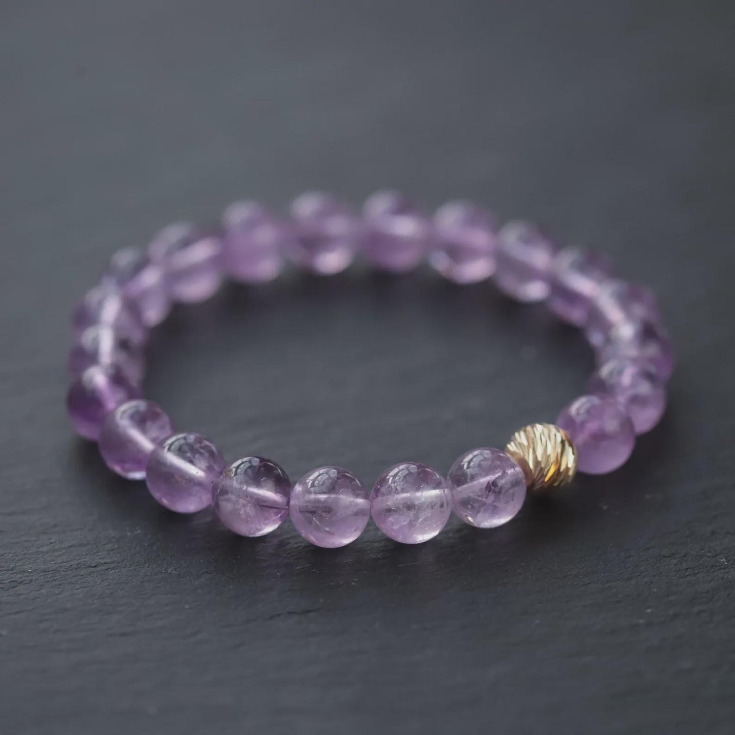 Lavender Amethyst bracelet with 14K gold accents from Earthly Abundance, featuring polished purple amethyst stones and gold clasp.