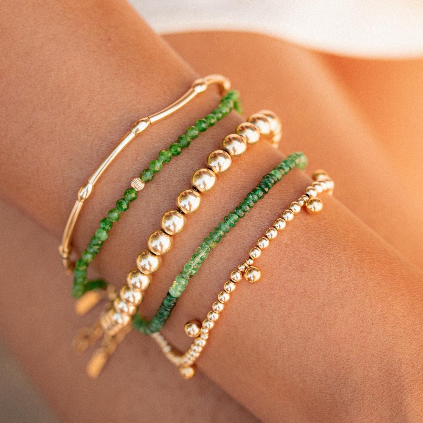 Heart-activating Tsavorite Ombré bracelet by Earthly Abundance featuring vibrant green and pink gemstones in a delicate design.