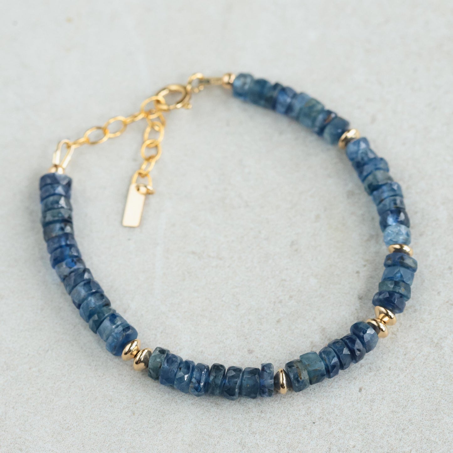 Kyanite Heishi bracelet with 14K gold-filled accents, featuring smooth round blue kyanite beads, handcrafted by Earthly Abundance.
