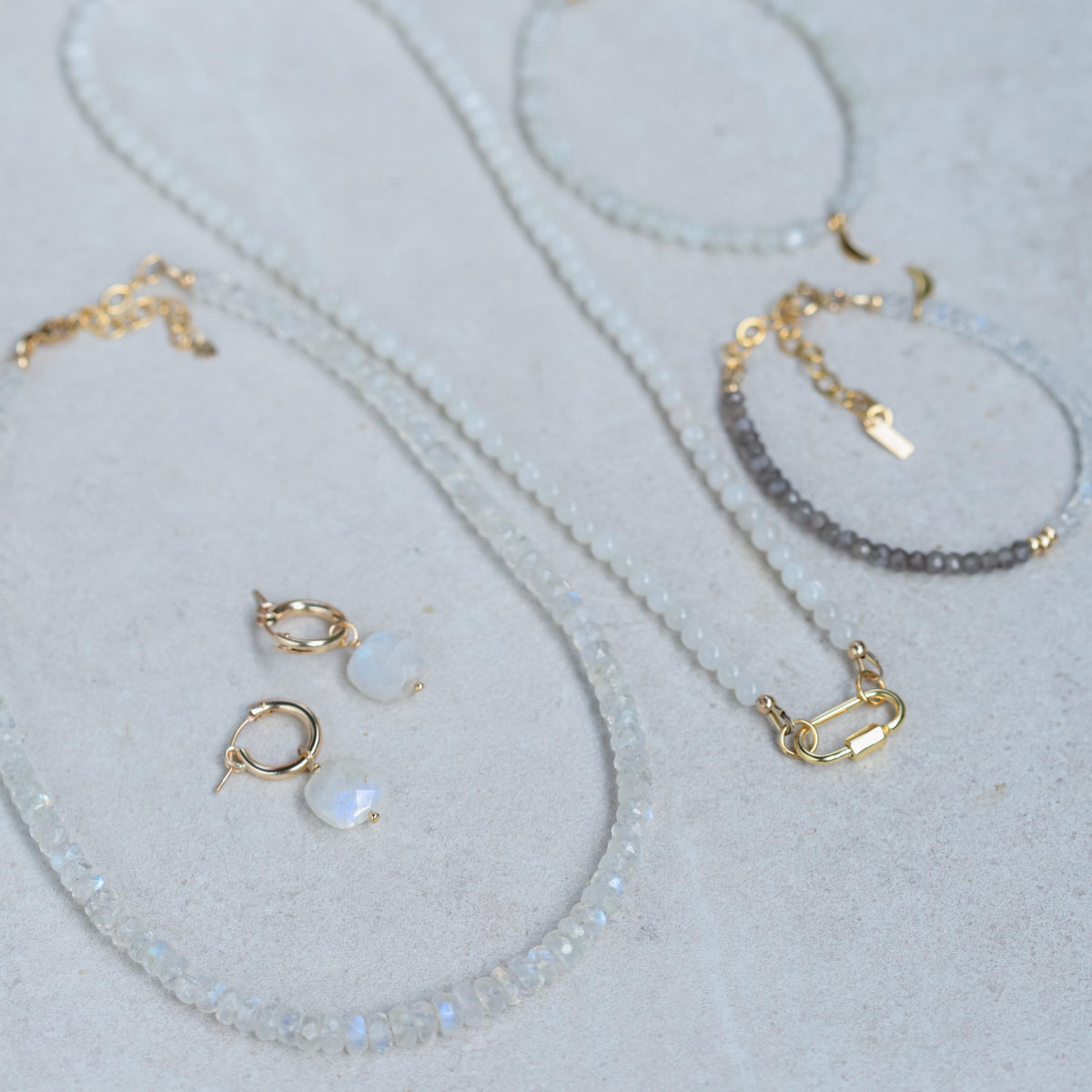 Earthly Abundance Luna Lock Necklace featuring a sleek, silver crescent moon pendant on a delicate chain.