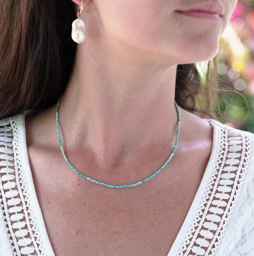 Turquoise 14K gold necklace from Earthly Abundance Jewelry featuring a vibrant turquoise pendant on a delicate gold chain.