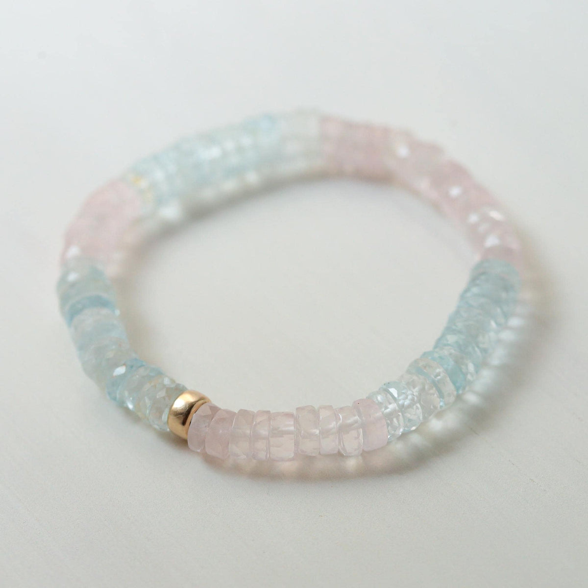 Pastel Morganite Beryl Heishi bracelet featuring soft pink and green beads, strung on a delicate cord, by Earthly Abundance.
