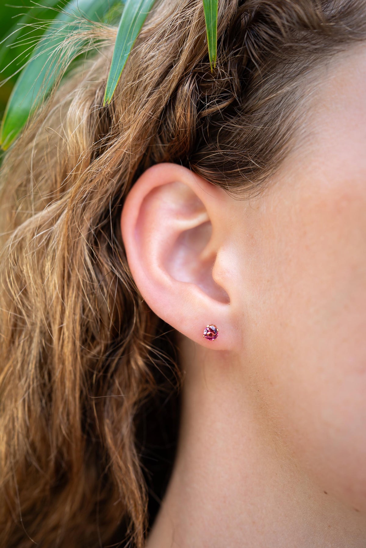 Pink tourmaline stud earring from Earthly Abundance featuring a sparkling pink gemstone set in a silver or gold stud.