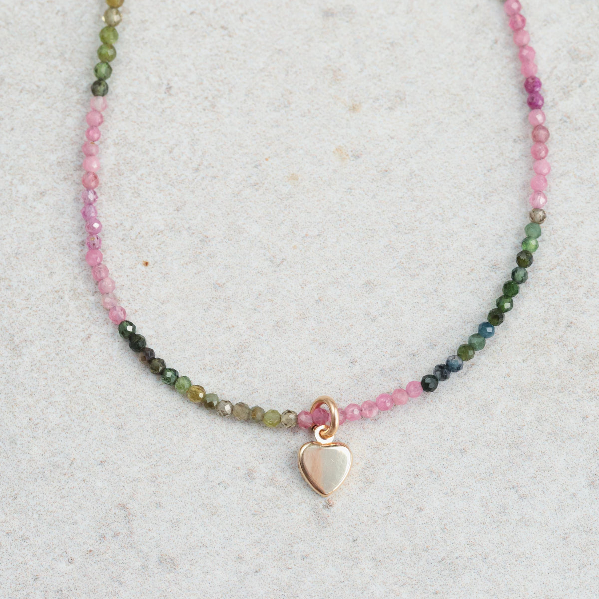 Mixed tourmaline heart necklace in 14K gold with a delicate chain, featuring colorful tourmaline stones, by Earthly Abundance.