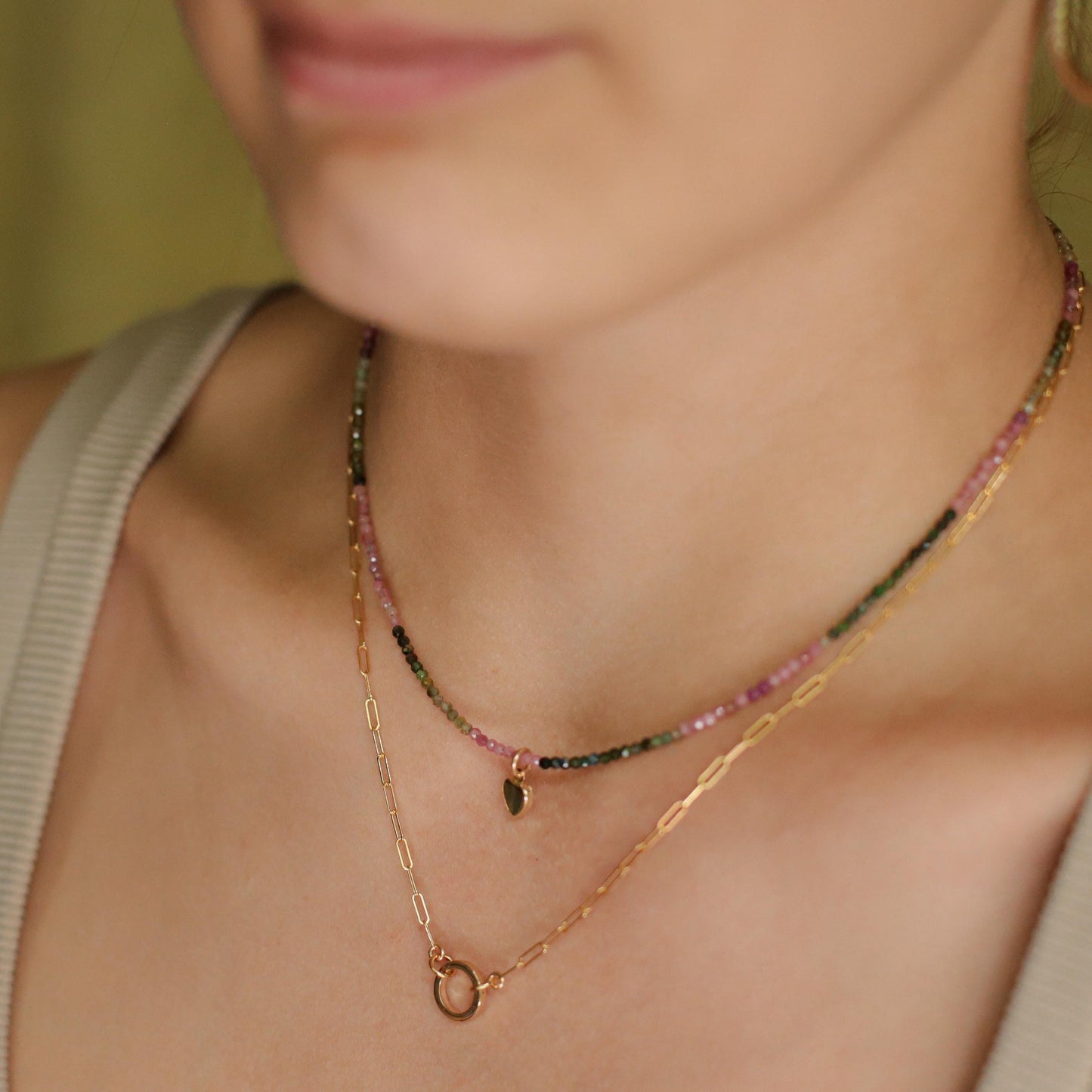 Mixed tourmaline heart necklace in 14K gold, featuring colorful heart-shaped gemstones on a delicate chain.