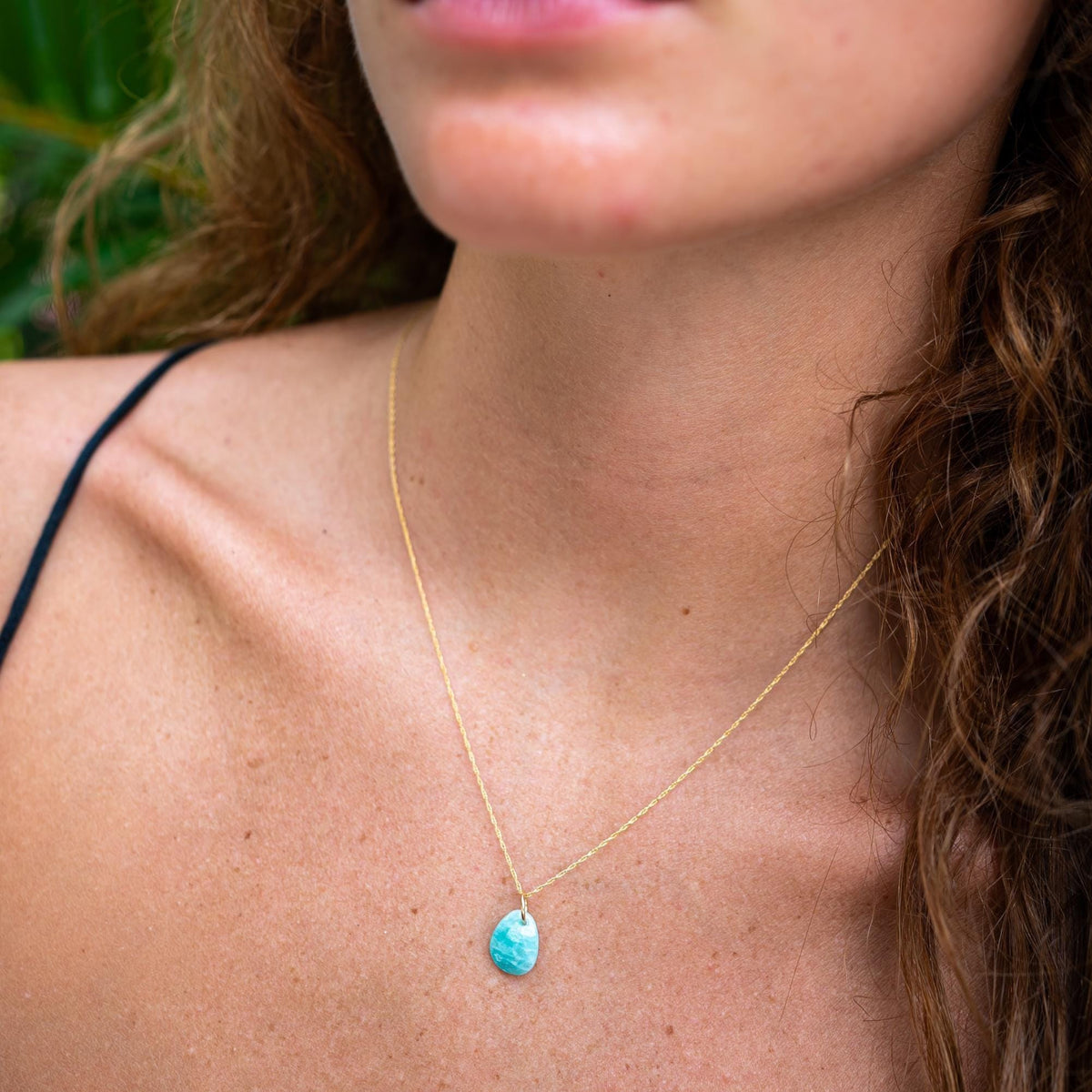 Amazonite pendant in 14K gold with a polished, natural stone setting, showcasing vibrant blue-green hues and elegant craftsmanship.