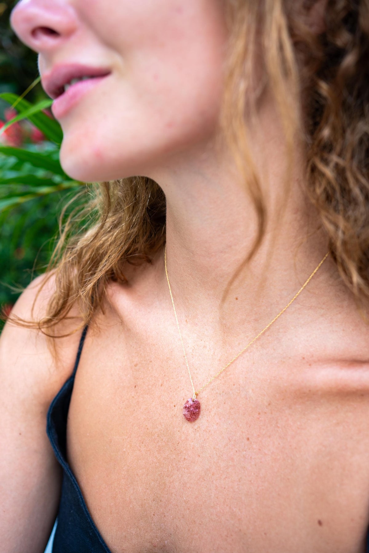 Strawberry Quartz pendant from Earthly Abundance featuring a polished pink gemstone on a silver chain.