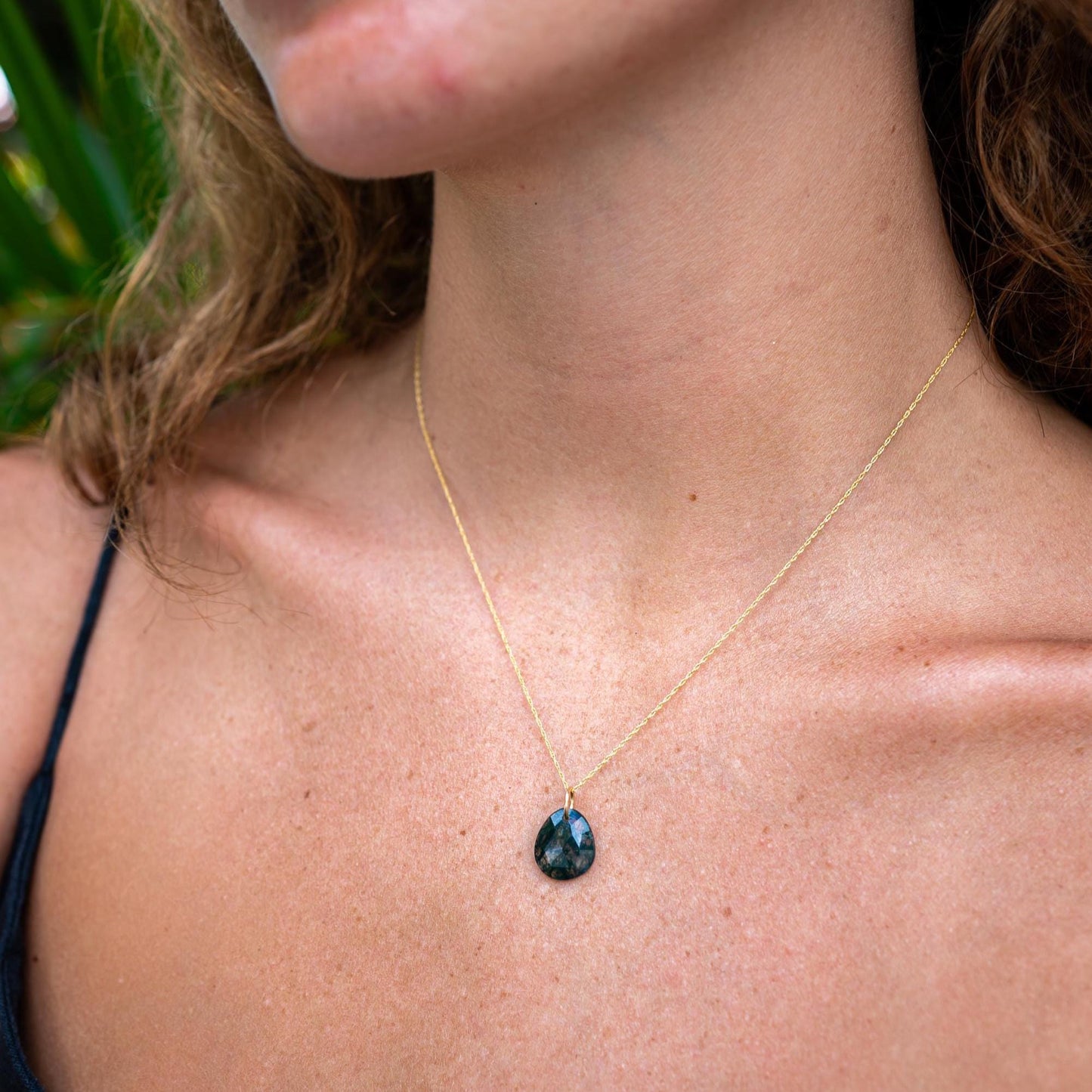 Earthly Abundance moss agate pendant featuring a polished oval gemstone with green and brown natural veining.