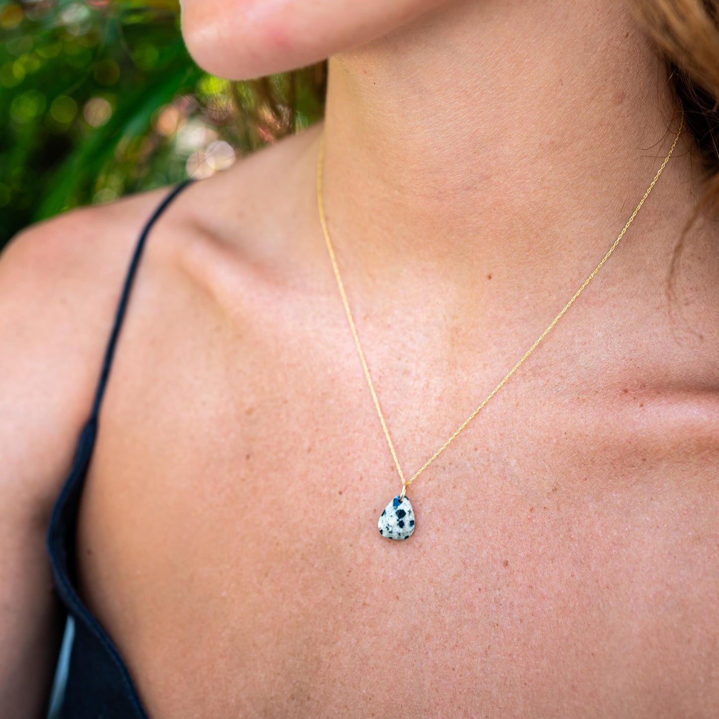 Dalmatian Jasper pendant by Earthly Abundance featuring a spotted, polished stone pendant on a cord.