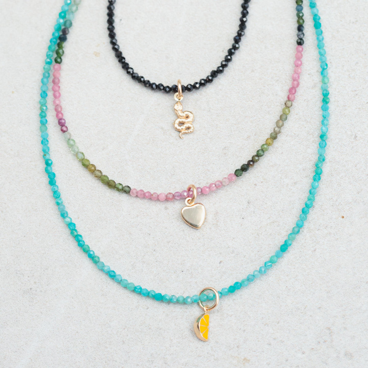 Mixed tourmaline heart necklace in 14K gold from Earthly Abundance, featuring multicolored tourmaline gemstones on a delicate chain.