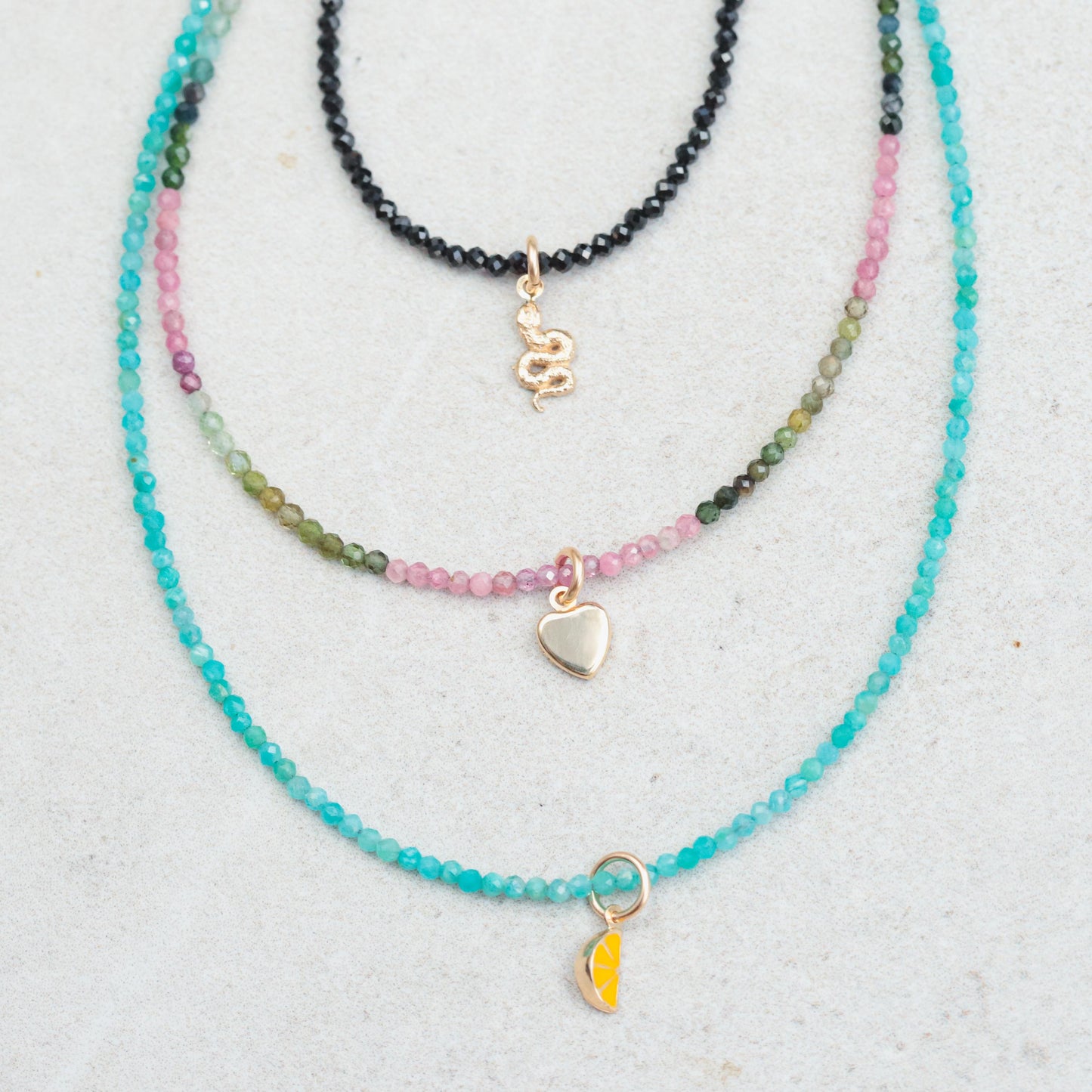 Black tourmaline snake necklace with 14K gold accents from Earthly Abundance, featuring a detailed snake pendant on a chain.