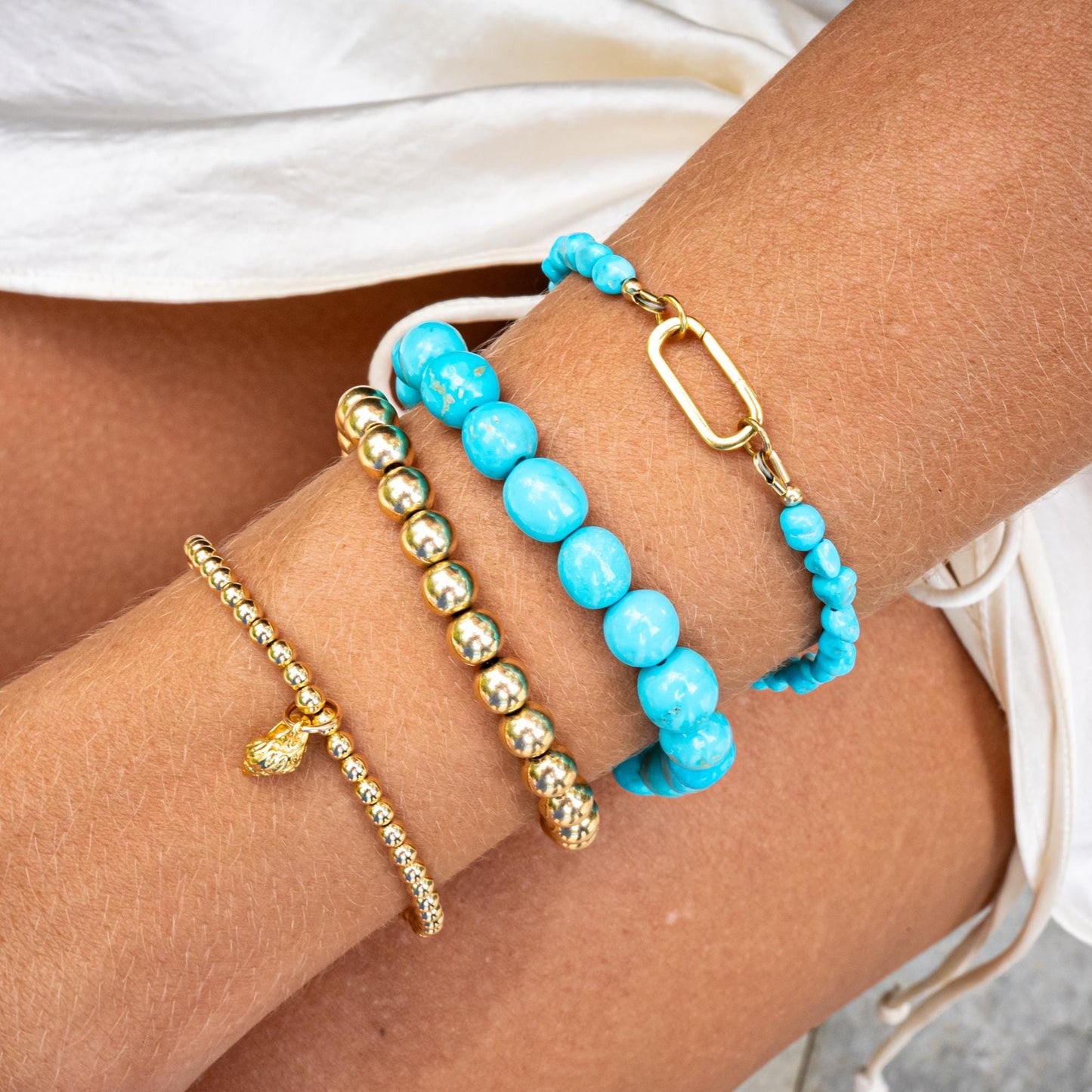 Earthly Abundance conch shell bracelet with natural shell beads and adjustable cord, close-up view of the jewelry piece.