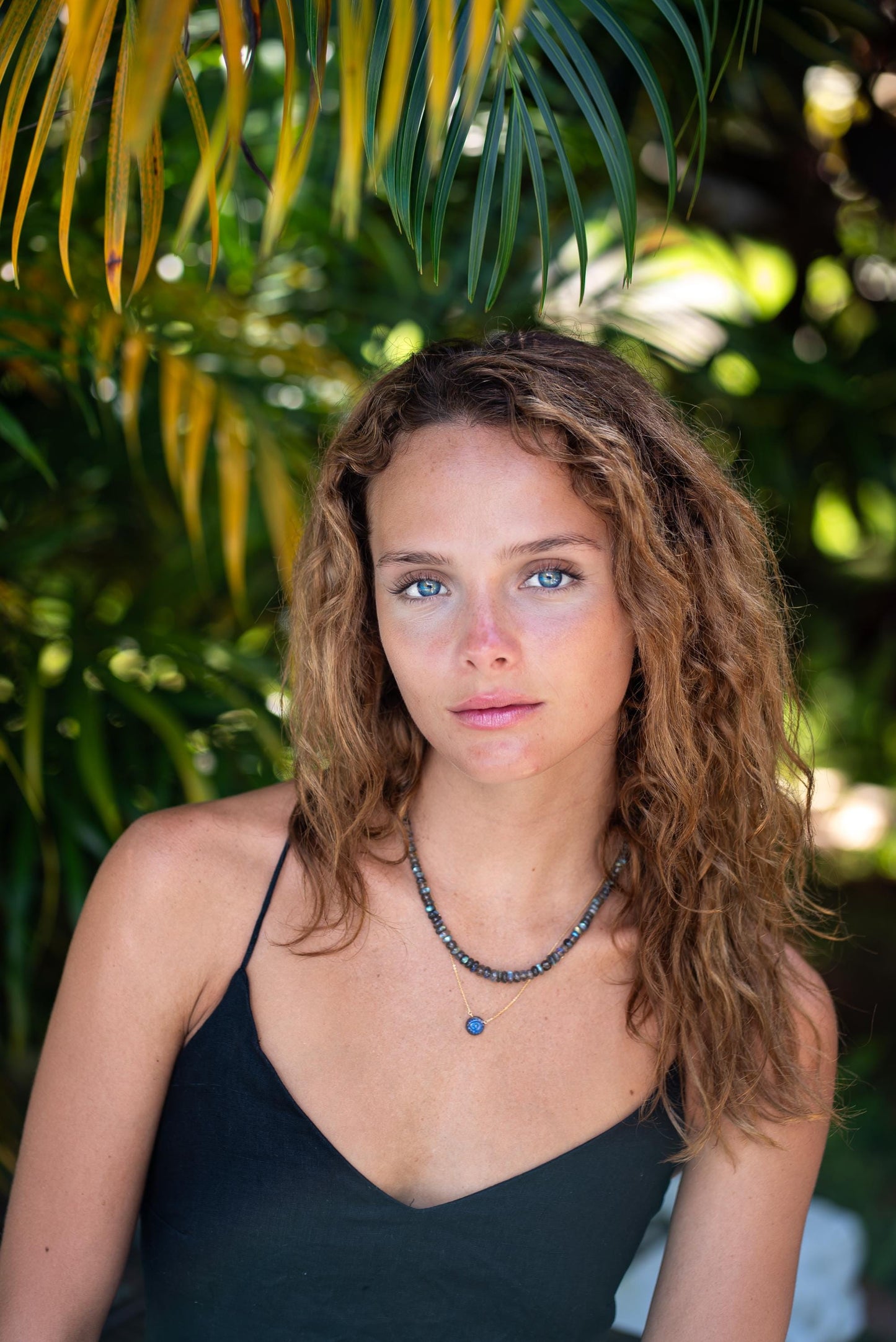 Evil eye labradorite pendant necklace with silver chain, featuring a mystical blue and gray labradorite stone and protective evil eye charm.