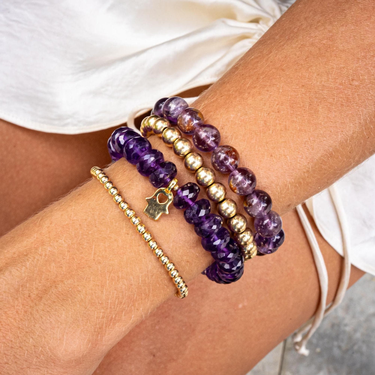 Cosmic Earth Auralite 23 bracelet featuring multicolored gemstone beads from Earthly Abundance on a white background.