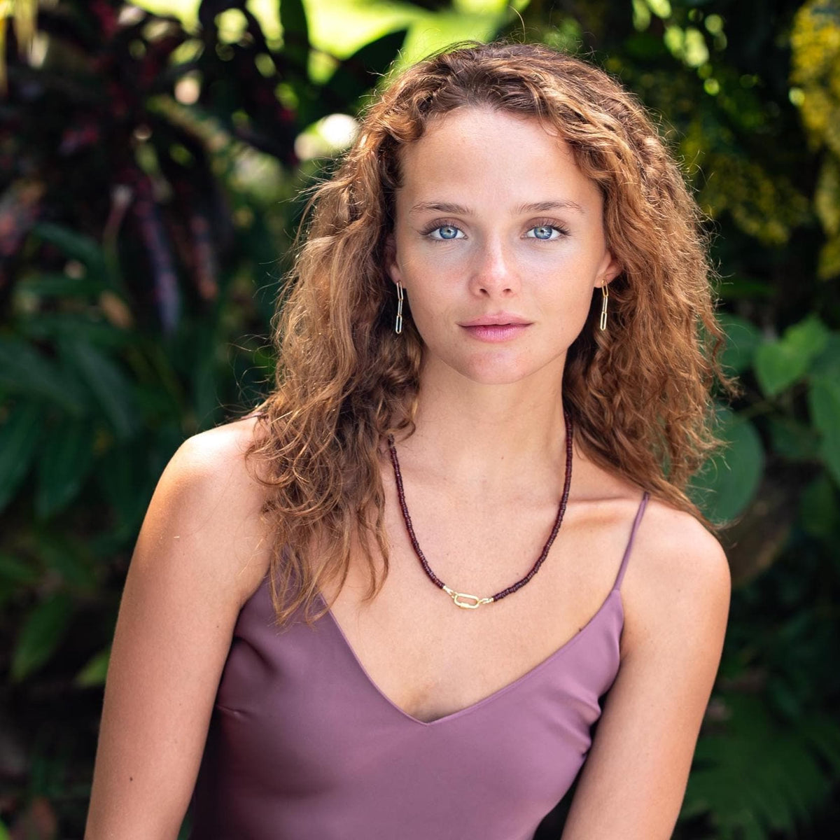 Earthly Abundance garnet beaded necklace featuring vibrant red gemstones on a delicate chain.