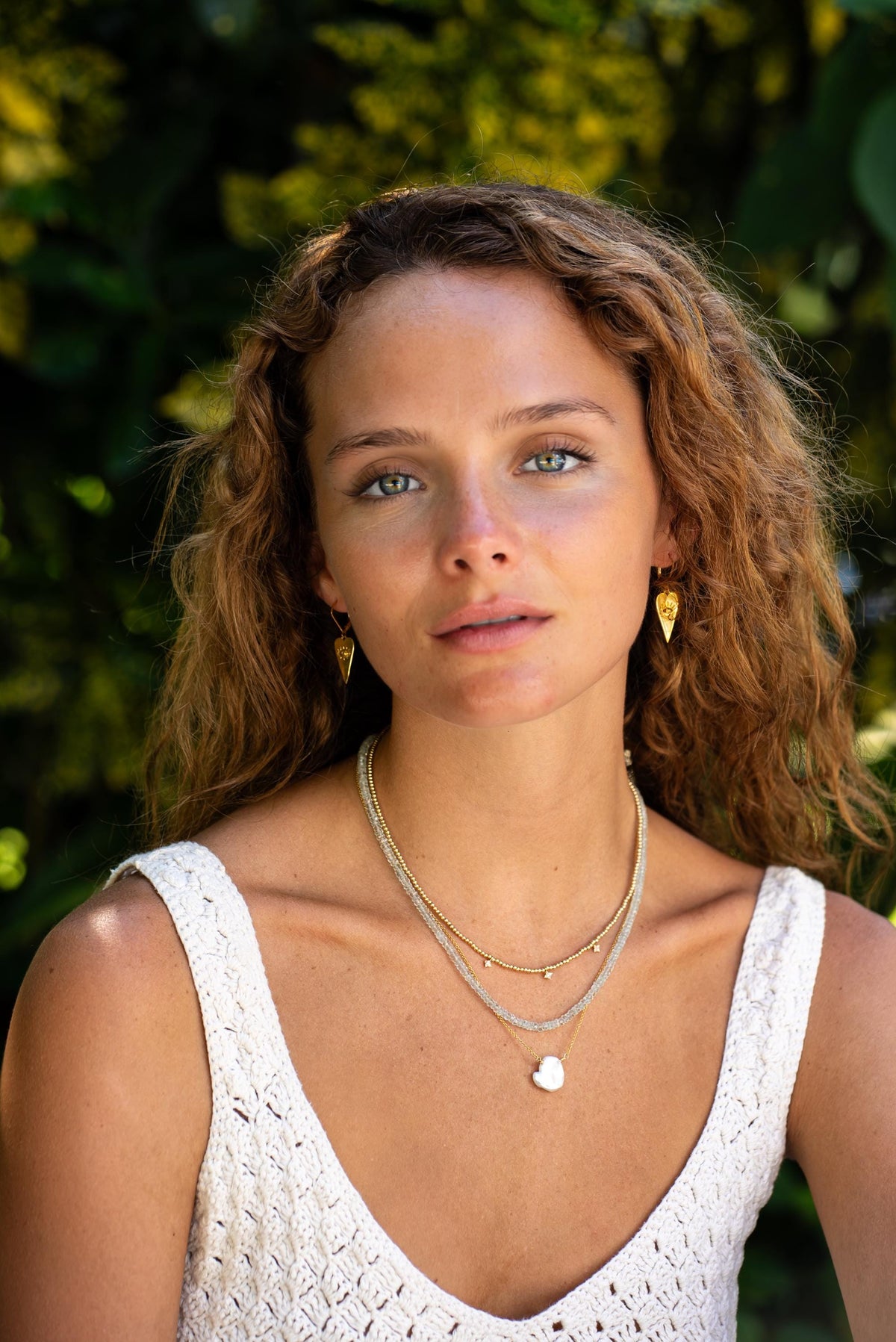 Earthly Abundance aquamarine choker necklace featuring a vibrant blue gemstone on a delicate chain.