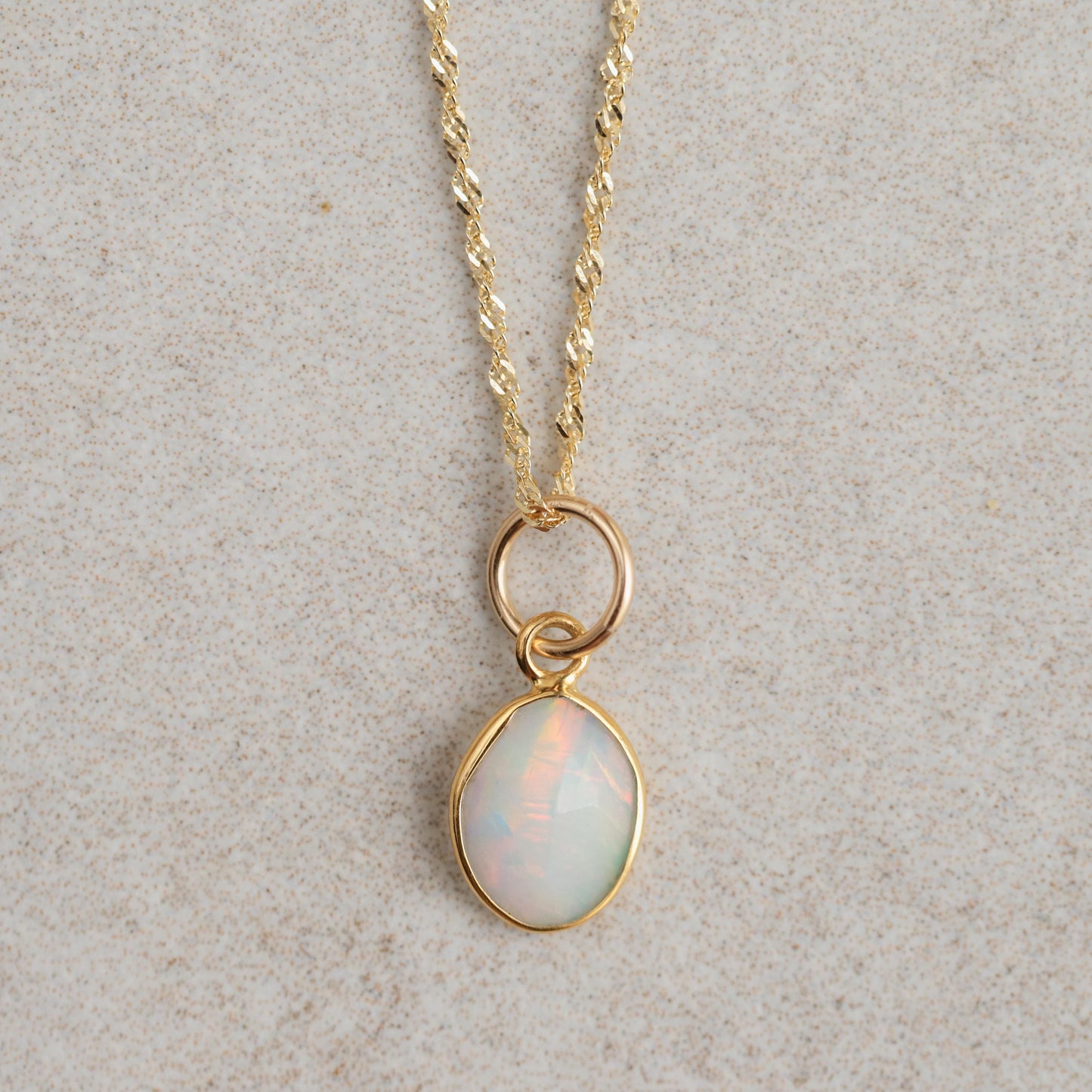 Ethiopian Opal Necklace with 14K gold chain from Earthly Abundance, featuring a vibrant, iridescent opal pendant on a delicate chain.