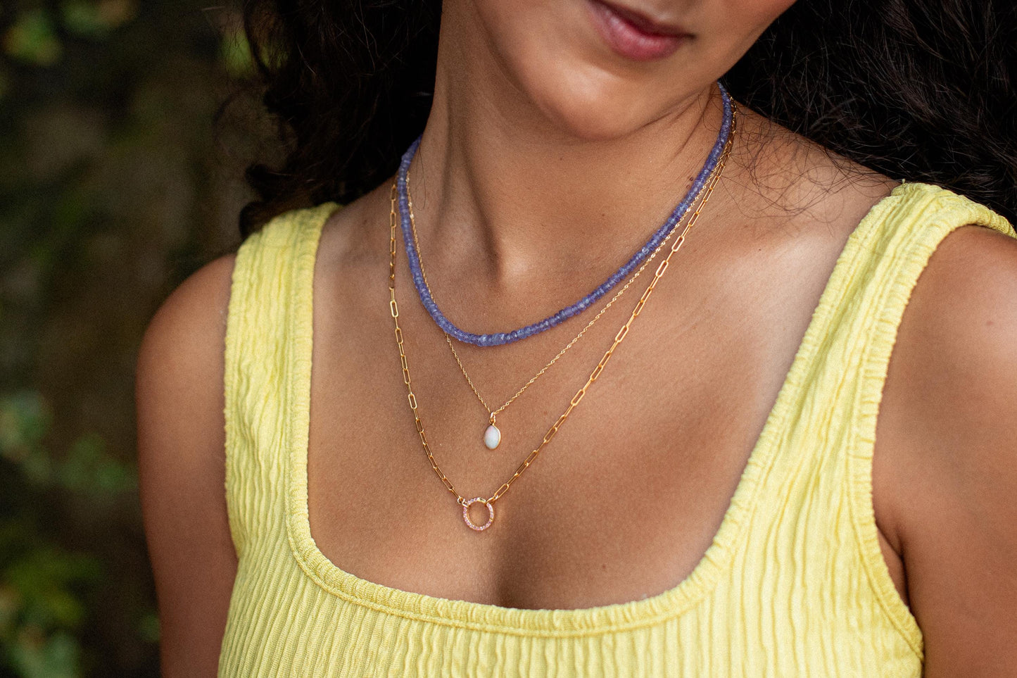 Ethiopian Opal necklace with 14K gold chain from Earthly Abundance, showcasing a vibrant, iridescent opal pendant on a delicate chain.