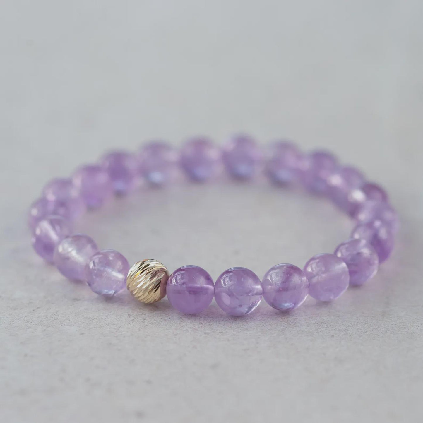 Lavender amethyst bracelet with 14K gold accents from Earthly Abundance, featuring polished lavender amethyst beads and gold clasp.