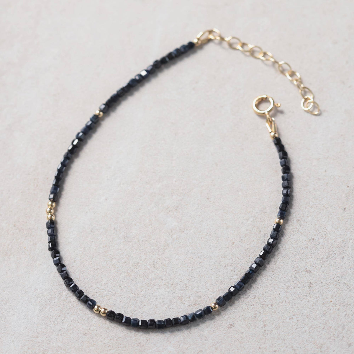 Blue sapphire cube anklet from Earthly Abundance featuring a delicate chain with blue sapphire cube charms.