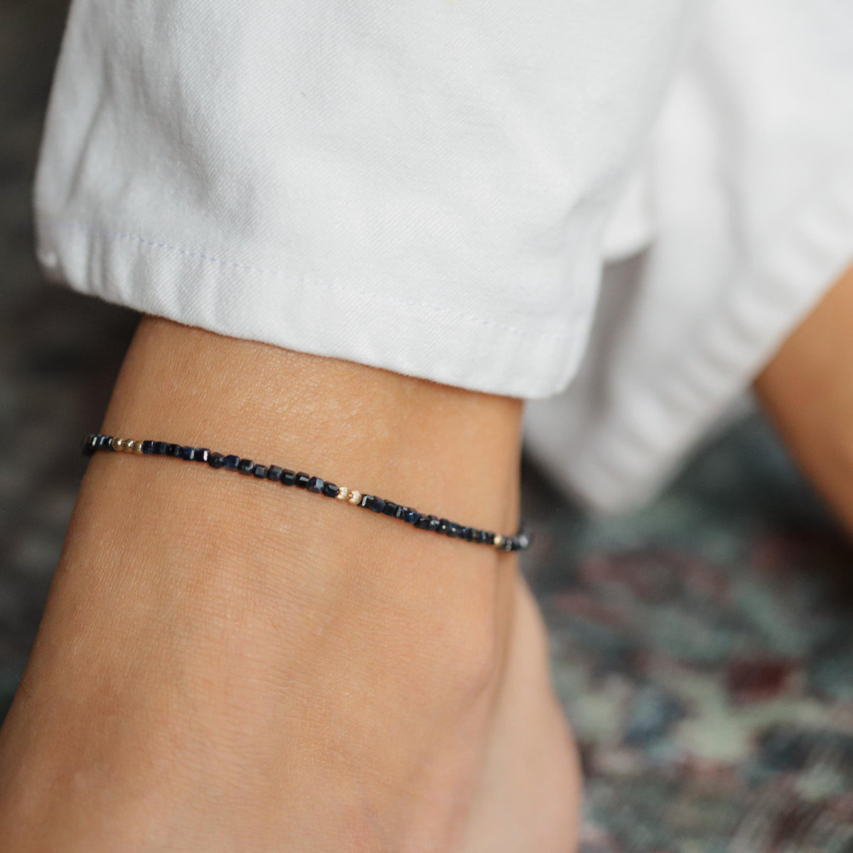 Blue sapphire cube anklet from Earthly Abundance featuring small blue sapphire beads on a delicate chain.